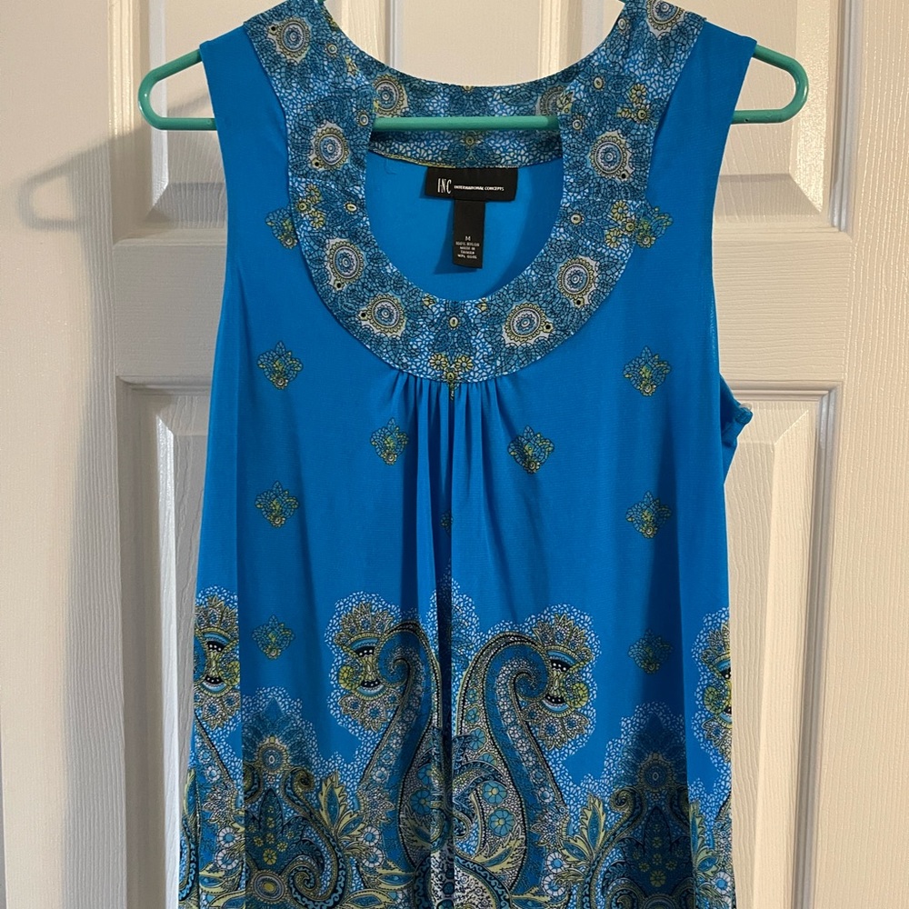Beautiful top, looks great under a jacket or on its own. 100% nylon size Medium
